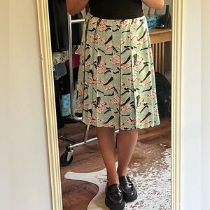 Carolina Herrera knee length mint color silk pleated skirt with swimmers pattern